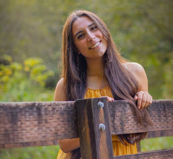 A woman leans against a railing