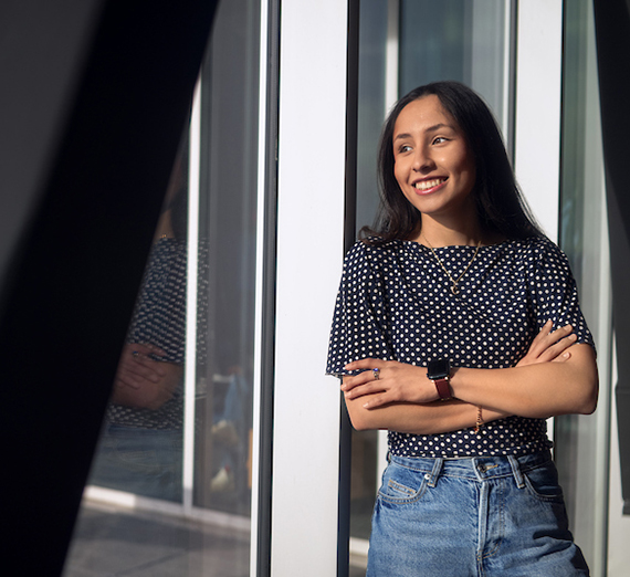 Woman in a t-shirt with a star on it leans against a railing